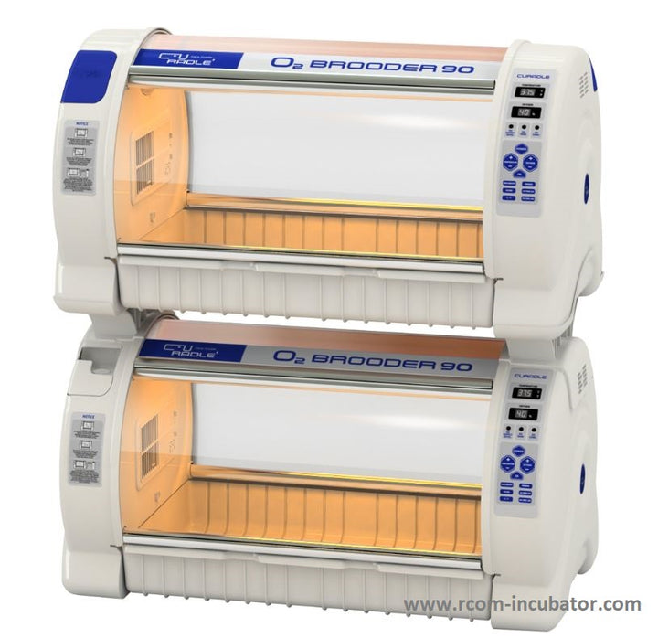 A  picture of two white and blue oxygen brooder 90s with a building rack used to stack them vertically reducing floorspace.