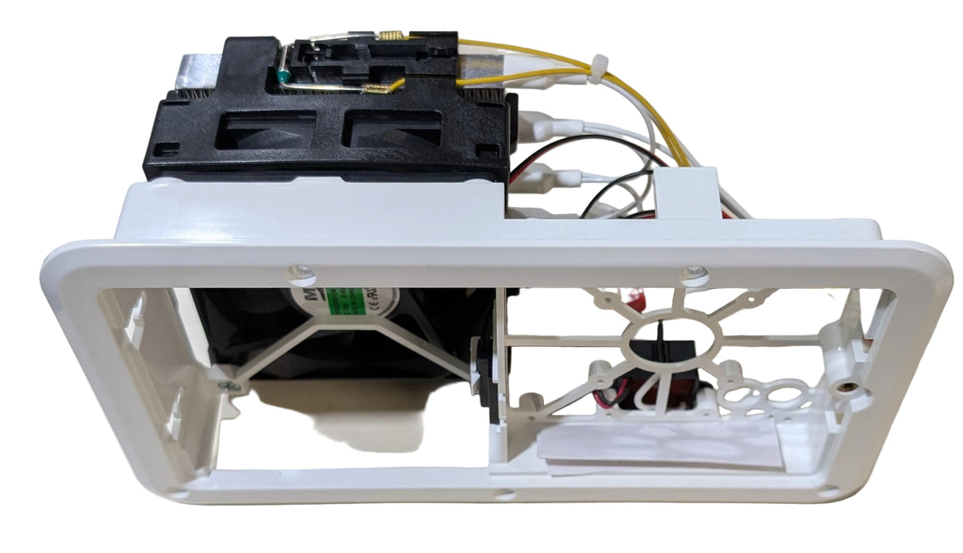 A white plastic replacement housing or frame component with attached black internal parts, wiring, and a small fan, photographed on a plain white background.