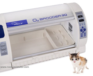 A picture of the white and blue oxygen brooder 90 showing a tray accessory that can be used for separating animals, a litter box, or as a birthing area.